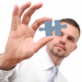 man_holding_missing_jigsaw_piece
